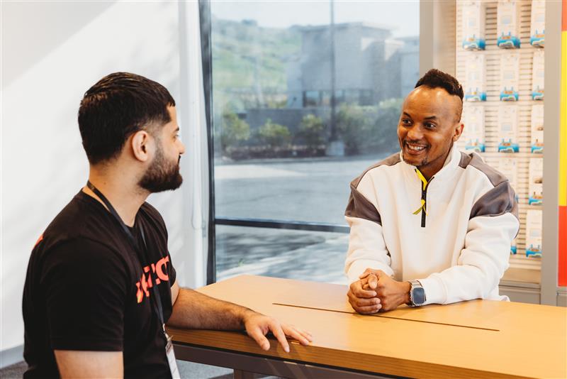 Wireless Plus team member helping a customer in store